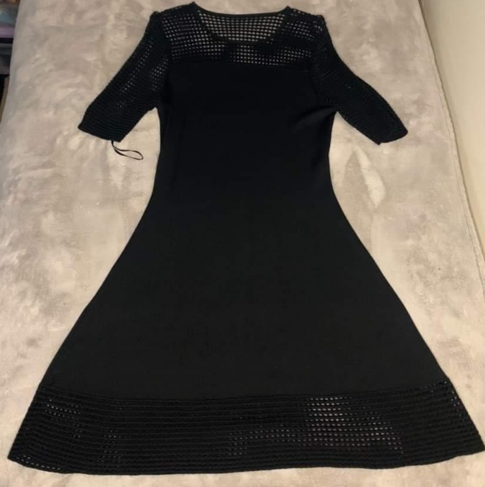 Black dress with see though top, sleeves, and bottom